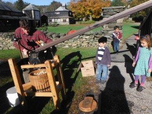 Carter helps us make apple cider with an apple roller coaster and an apple press.