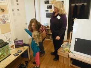 Isabelle shows her grandmothers her fish pictures.